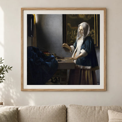 Woman Holding A Balance (c. 1664) — Johannes Vermeer shown in a styled interior