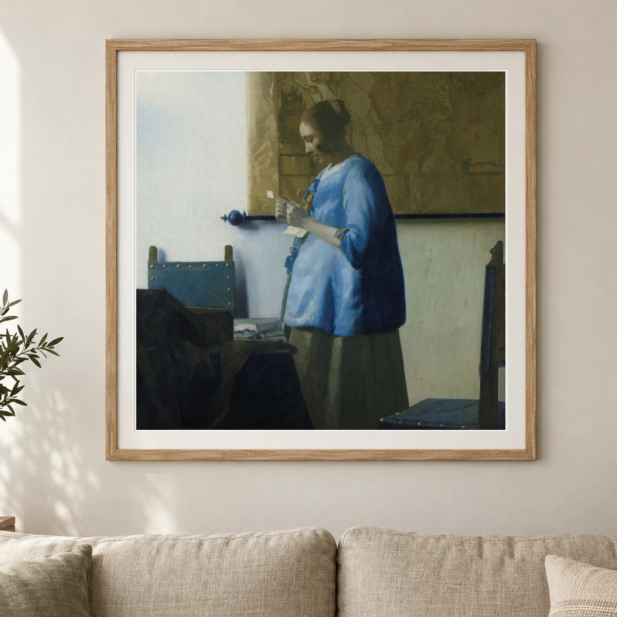 Woman Reading A Letter (c. 1663) — Johannes Vermeer shown in a styled interior